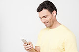 Smiling guy sending a text message