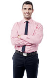 Smiling businessman with crossed arms
