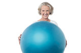 Senior woman posing with exercise ball