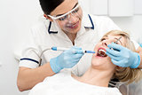 Dentist curing a woman teeth