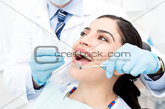 Female getting her teeth examined