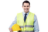 Smiling engineer with safety helmet