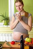 Pregnant woman on kitchen cooking