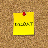Yellow stick note paper with word DISCOUNT pinned on cork board 