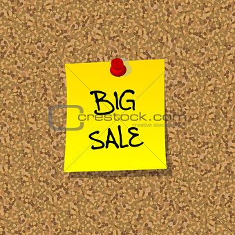 Yellor stick note paper with words BIG SALE pinned on cork board