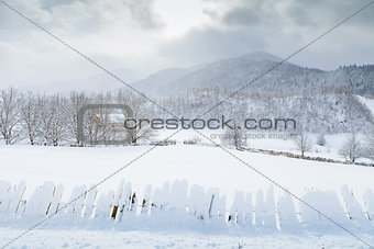 Snow fence and Caucasus Mountains