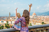 Mother and baby girl looking on panoramic view of florence, ital