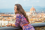 Happy young woman against panoramic view of florence, italy