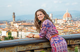 Portrait of happy young woman against panoramic view of florence
