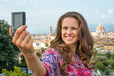 Happy young woman making selfie in front of panoramic view of fl