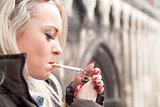 tourist lighting up a a cigarette in an European city
