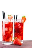 two glasses of strawberry cocktail with ice and strawberry on top