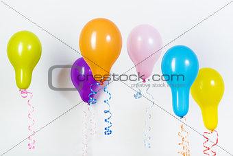 Balloons of different bright colors on a white background