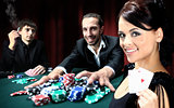 Poker players sitting around a table at a casino