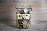 Money jar with education fund label.