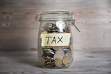 Money jar with tax label.