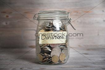 Money jar with donations label.