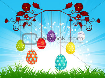 Dangling Easter eggs on blue sky landscape