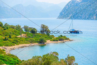 sailing yacht in the beautiful sea bay in the mountains