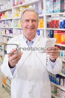 Senior holding medicine box and prescription