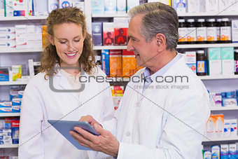 Team of pharmacist looking at tablet pc