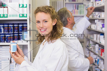 Pharmacist holding medicine jar