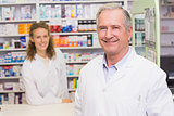 Smiling pharmacists looking at camera