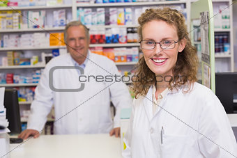 Smiling pharmacists looking at camera