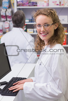 Happy pharmacist looking at camera