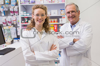 Smiling pharmacists with arms crossed