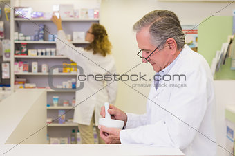 Senior pharmacist mixing a medicine