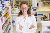 Portrait of a smiling pharmacist in lab coat looking at camera