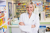 smiling pharmacist in lab coat looking at camera