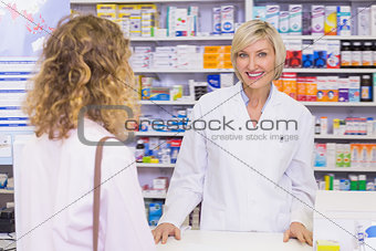 Smiling pharmacist looking at camera