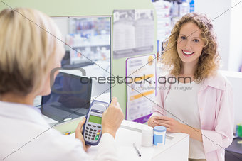 Pharmacist using card machine