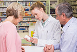 Pharmacist showing medicine jar