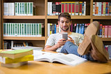 Student listening music in the library with smartphone