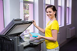 Student photocopying her book in the library