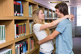 Cute couple embracing each other in the library