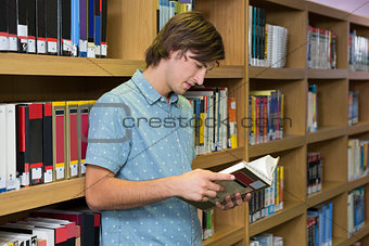 Student reading book in library