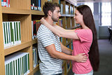 Cute couple embracing each other in the library