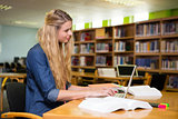 Student studying in the library with laptop