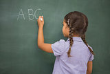 Pupil writing letters on a blackboard