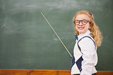 Happy pupil pointing the blackboard
