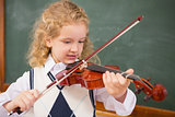 Cute pupil playing the violin