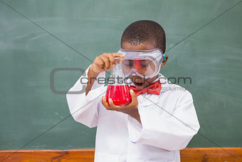 Surprise pupil looking at a red liquid