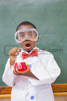 Surprise pupil holding at a red liquid