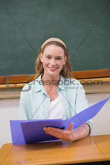 Teacher reading papers at her desk