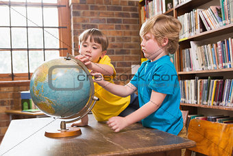 Cute pupils looking at globe