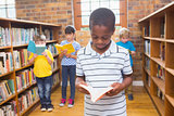 Pupils looking for books in library